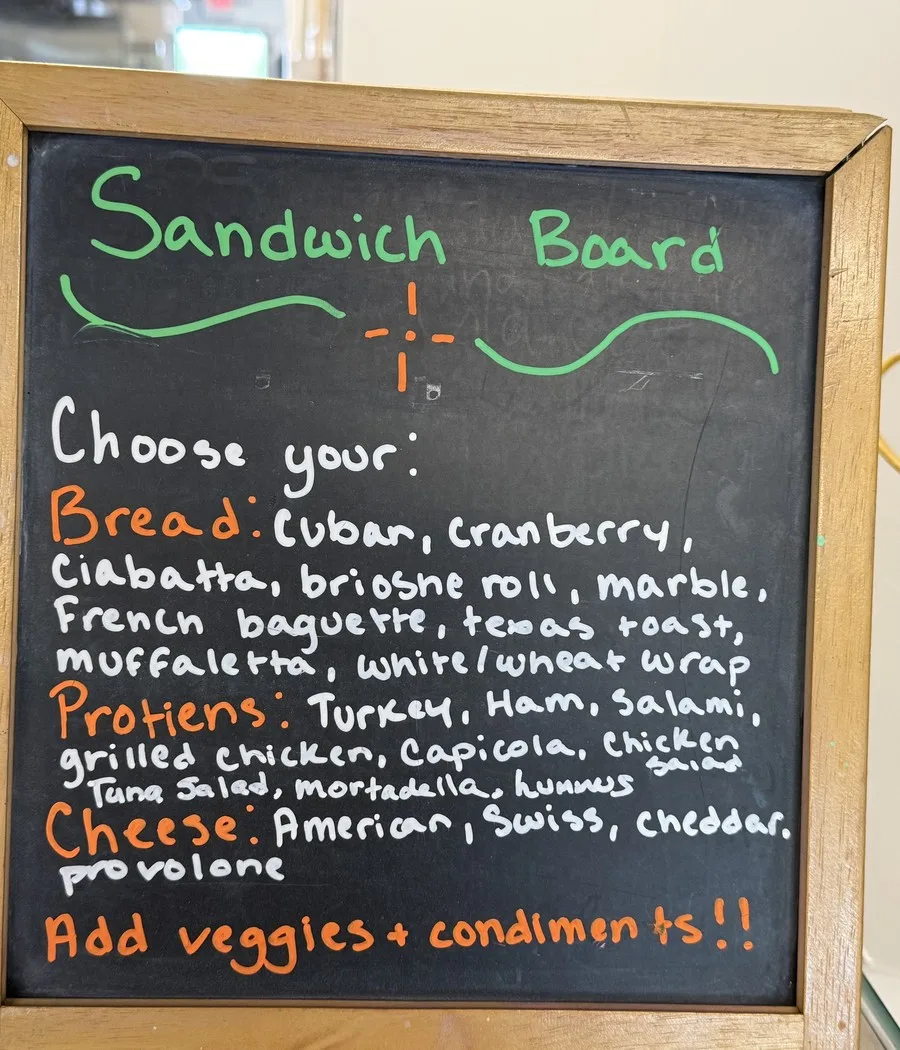Sandwich Board sign listing build-your-own bread, protein and cheese options