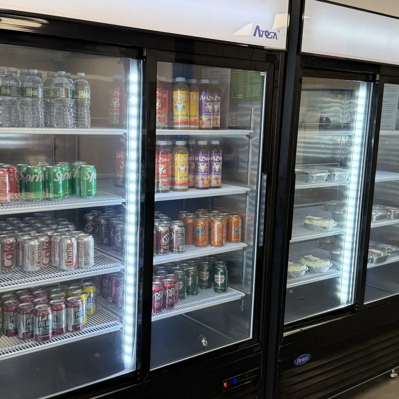 Cold drink cooler stocked with sodas, juices and seltzers at Delishh